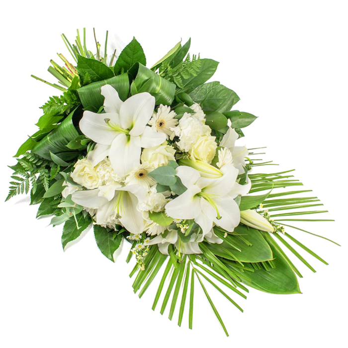 A contemporary, teardrop-shaped funeral tribute is shown against a clean white backdrop, composed entirely of white blooms and layered greenery that evoke peace and gentle reflection. The arrangement is designed as a one-sided spray, with its generous cluster of flowers positioned toward the upper left and tapering elegantly down to a slender point at the lower right. Dominating the central section are large white Oriental lilies; some are fully open, with wide, satin-like petals and soft yellow-green stamens, while others remain in long, elegant buds that lend height and promise. Interspersed among the lilies, creamy white roses, frilled carnations, and neat white Gerbera-style daisies create a harmonious mix of shapes and petal textures. Fine stems of tiny white filler blossoms sparkle between the larger flowers, adding a lace-like lightness. The blooms are cradled by a rich underlay of foliage: broad, dark green leaves with a glossy sheen; feathery fern plumes; and rounded eucalyptus leaves with their characteristic cool blue-green cast, suggesting a subtle, clean fragrance. At the top, a small bundle of narrow green leaves is artfully looped and secured, creating a vertical sculptural detail that guides the eye upward. From the lower right, slim palm fronds extend and fan out, giving motion and a sense of flow, and defining the arrangement's elongated, slightly diagonal silhouette. The overall impression is dignified yet soft, a piece that would sit beautifully in a Clerkenwell memorial space or chapel, offering quiet solace to families saying goodbye within this historic London neighbourhood.
