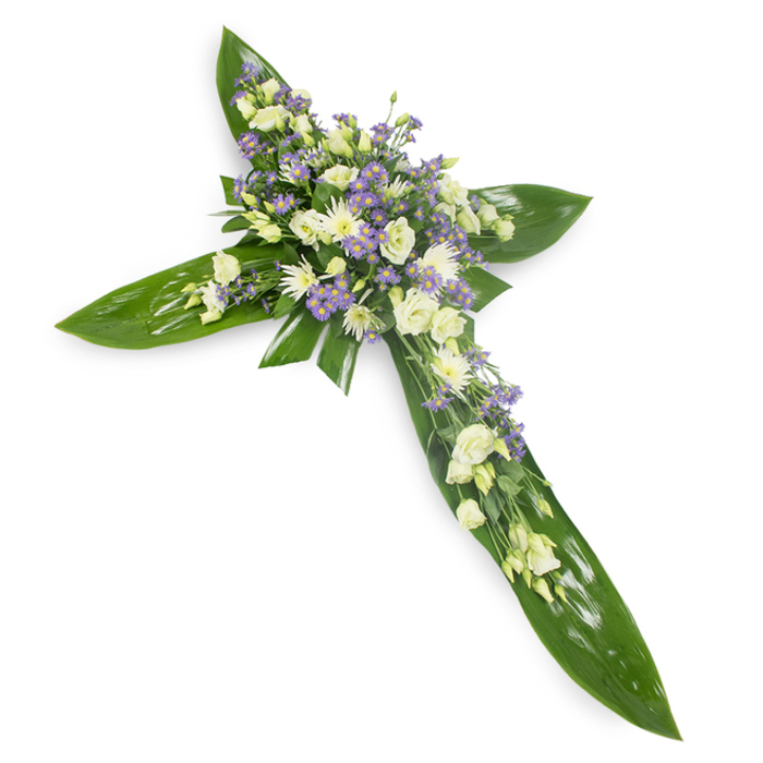 This floral cross is presented against a crisp white ground and photographed from a slightly elevated viewpoint so the viewer can take in the careful geometry and texture. The foundational silhouette is crafted from large, verdant tropical leaves whose glossy surfaces and visible veins are layered to create the cross's arms and central core. Resting upon that green framework is a composed, abundant cascade of soft white and ivory flowers: lisianthus with their paper-soft ruffles and unopened buds provide a gentle, almost human tenderness, while clusters of small white chrysanthemums or miniature blooms give punctuated highlights and a quiet resilience. Scattered among these are slender sprays of pale lavender aster or limonium that lend a subtle, cooling contrast and a sense of air and depth. Fine green foliage is woven through the petals, softening transitions and lending an organic rhythm to the piece. Light is soft and even, bathing the arrangement in a calm, devotional radiance suitable for a funeral service, memorial or religious ceremony. As an experienced florist working in Clerkenwell and familiar with the nearby markets and parish traditions, I see this cross as both an emblem of faith and a gentle comfort; it embodies respectful craftsmanship and is intended to offer solace, suggesting eternal peace while speaking with a restrained, heartfelt elegance.