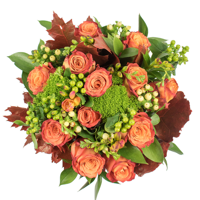 Viewed straight down on a crisp white surface, this densely packed bouquet celebrates autumn with a painterly mix of color and texture. The composition is dominated by large, fully bloomed roses whose petals graduate from a warm peach at the centre to richer coral and deep orange, with outer edges brushed in a reddish-rust that echoes late-season foliage. Nestled amid the roses are clusters of Hypericum berries in lively lime-green and pale creamy-yellow, their small round shapes providing bright, jewel-like accents against the soft petals. Patches of Green Trick dianthus - compact, velvety and mossy - introduce a dense, tactile contrast that reads almost like miniature green cushions between the flowers. A variety of fresh green leaves, some broad and glossy, some more delicate, create a lush backdrop, while pronounced lobed leaves in burgundy and burnt umber are used sparingly to suggest fallen leaves and to ground the palette. The bouquet's circular, top-down arrangement is intentionally abundant and elegant; diffused light reveals the velour of the rose petals, the sheen on the berries, and the subtle serration of the foliage, creating depth through soft shadowing. Perfect as a Thanksgiving centrepiece, a seasonal gift, or to warm a Chelsea-style sitting room near Clerkenwell's artisan cafes, this arrangement feels both sophisticated and homely. The overall impression is one of harvest-time comfort - tactile, fragrant and composed with the attentive hand of a local florist who knows the neighbourhood's seasonal rhythms.
