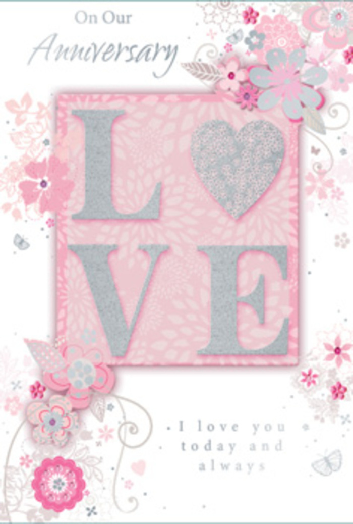 In this detailed image, an anniversary card is presented as though it has just been placed on a tidy table in a Clerkenwell townhouse, bathed in soft natural light. At the heart of the design is the word LOVE, printed in large capital letters that rise slightly from the surface, their edges kissed with delicate glitter. The effect is a frosted, tactile shimmer, catching hints of silver and pale pink as the light glides across each letter. The central panel beneath the word is a gentle blush pink, a touch deeper than the surrounding background, creating the sense of a framed keepsake or a special note layered within the card. Around this centrepiece, wispy, hand-drawn floral motifs drift and curl, as if a florist had imagined a bouquet directly onto the page. Slim stems loop into soft scrolls, supporting petals in blush, ivory, and powder-grey, with subtle silver accents that trace the outlines like fine threads. The flowers are not heavy or crowded; instead, they float with an airy grace, loosely gathered like a just-picked spring posy. The pale pink background provides a velvety, uniform canvas, setting off the raised shimmer of the letters and the jewel-like quality of the silver highlights. Along the lower or side edges, an understated anniversary message appears in a gentle script, the lettering smooth and rounded, echoing the card's overall softness. The composition feels affectionate and sincere, like a quiet promise whispered on a side street near St John Street: a paper expression of devotion, combining the romance of pastel flowers with the intimacy of a hand-written note shared year after year.