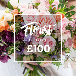 Seen through the practiced eye of a florist, this bouquet feels like a celebration of craft and seasonal generosity. Multiple large, blush and pale-pink garden roses form the romantic centre, their many-layered petals soft to the touch and edged like antique lace; around them, pale purple-and-white sweet peas lend a scented, flitting lightness while coral and peach ranunculus offer tighter, jewel-like blooms. Darker plum-toned hellebore or similar textured florets are woven low in the arrangement, giving a quiet, dramatic weight that balances the palette and draws the eye through layers of texture. Creamy white filler flowers flicker like small lanterns among the greens, and the foliage - from slender trailing tendrils to broader matte leaves - creates movement and an authentic garden-style silhouette that feels freshly gathered rather than overly formal. The image captures soft, natural light that highlights petal translucence and the faint dewy scent you might notice when stepping into a flower stall on Leather Lane; a pair of hands, sleeves blurred and neutral, hold the stems with careful economy, signalling the bouquet has been hand-finished and perfectly tied. Although this description reads like a personal appraisal rather than a catalogue caption, the photograph also includes a subtle white overlay box with elegant script announcing a florist-chosen arrangement and a clear price marker of "?100", indicating a premium, florist-selected product ideal for weddings, anniversaries, or a heartfelt gift delivered locally in Clerkenwell.