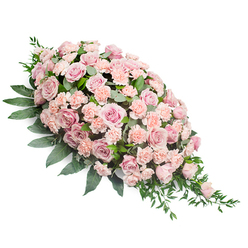 Set against a spotless white background, a long, elegant teardrop-shaped funeral spray stretches diagonally, full and rounded at the upper left and gently narrowing to a refined point at the lower right, as if reaching out in a final, tender blessing. The heart of the design is a profusion of pastel roses in shades of blush and soft shell pink, each bloom layered with silken petals that appear almost touchably smooth, from wide, open flowers to more modest, cupped buds. Threaded between them are delicate light peach-pink carnations, their frilled edges providing a soft, cushion-like texture that cradles the roses and amplifies their gentle colour. A rich bed of dark, polished foliage surrounds and supports the flowers, with sturdy, glossy leaves hugging the base and slightly arching outward, while finer stems of trailing greenery and feathery fronds spill from the pointed end, giving the spray a sense of quiet motion. The palette of dusky pinks and deep greens feels calming and dignified, echoing the atmosphere of a still corner near Clerkenwell Green or a peaceful service at a local chapel. Every element appears fresh and carefully placed, suggesting the thoughtful hands of an experienced florist attuned to the emotions of loss and remembrance. This sympathy spray, designed to rest on a casket, grave, or memorial stand, conveys a message of tender support and enduring love, suitable for families gathering in Clerkenwell and the nearby Farringdon and Angel areas to say their goodbyes.