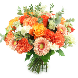 Bathed in clean daylight against a pure white backdrop, this hand-tied bouquet reads like a pocket of sunshine from a Clerkenwell studio. At its heart are generous roses in saturated orange and sunny golden-yellow tones, their layered petals velvety and slightly spiralled. Surrounding them, coral and peach carnations lend a lush, ruffled volume-soft scalloped edges that contrast with the roses' smooth curves-while soft peach-pink and vivid orange gerbera daisies open with flat, inviting faces and gentle greenish centres. Tiny white accent flowers, possibly freesia or delicate spray blooms, are sprinkled through the massed petals to lift the warm palette with bright, pure highlights. Pale green, starry filler blossoms similar to Astrantia peek through and add a wispy, garden-fresh texture that keeps the composition light.

Cool, rounded eucalyptus leaves in silvery grey-green are threaded around the blooms, providing a soothing backdrop and a subtle, refreshing scent when the bouquet is carried. The stems are tightly gathered and tied, reflecting the careful, hand-finished style Clerkenwell Flowers uses for local deliveries around Leather Lane and Farringdon. The overall effect is joyful and refined, a perfect gift for birthdays, anniversaries or to bring warmth to a bedside or dining table. This bouquet balances tactile contrasts-velvety rose petals, frilly carnation layers, crisp foliage-and reads as both a professional floral statement and a friendly, neighbourhood offering.