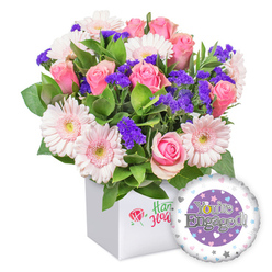 Within Clerkenwell's charming streets, this bouquet radiates with lively pinks set in a crisp white square box, a signature display that speaks of thoughtful celebration. The pink roses dominate, their petals unfurling in creamy spirals, while pale pink gerberas glow with moonlit cheer. The purple statice adds a hint of mystery, like a whispered secret among the blooms, and the abundant green foliage frames the arrangement with a gardener's care. The box offers a clean, modern backdrop that lets the colours breathe, a timeless choice for engagement gifts found around Clerkenwell Green and nearby lanes. Beside it, a round foil balloon punctuates the scene, its central purple circle housing You're Engaged! in gleaming silver letters and a golden O reintegrating a ring into the typography. The outer ring hosts tiny pastel hearts and delicate stars, catching the light as you move.

This bouquet is crafted for celebrating a couple taking the next step, whether you're presenting it across a kitchen table on Clerkenwell Green or delivering to a Waterloo Street apartment near Farringdon. The freshness of the stems, the subtle scent of the pink blooms, and the clean geometry of the white box combine into a gift that feels personal and sincere. It makes a heartfelt statement for engagements, anniversaries, or romantic milestones, with reliable same-day delivery across Clerkenwell and surrounding communities, sharing joy with nearby friends and family.