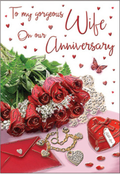 This anniversary card scene unfolds like a tender love letter laid out on a sunlit table in Clerkenwell, composed with a calm, steady elegance. A tight cluster of crimson red roses anchors the design, their petals lush, layered, and almost touchable, capturing that classic symbol of enduring romance. Around them, sprigs of glossy greenery curve and weave, providing a natural contrast that recalls the quiet greenery of local squares and hidden lanes off St John Street. Nestled beside the bouquet is an envelope, slightly angled, its surface smooth and inviting, hinting at heartfelt words penned by hand rather than typed. A dainty piece of jewellery and a heart-shaped keepsake box rest nearby, carefully placed as though just taken out to be admired before an anniversary dinner. Scattered across the composition, tiny heart motifs shimmer softly, their shapes echoing the emotional theme without overwhelming the scene. A single butterfly design appears to float above the arrangement, adding a gentle sense of movement and hope, like a brief flutter through an open Clerkenwell studio window. The lighting is warm but diffused, highlighting the rich reds and subtle metallic flashes of the jewellery without harsh glare, creating a soothing, intimate mood. Everything in the image-from the curve of each rose petal to the deliberate spacing of the decorations-feels considered and personal, much like an anniversary bouquet prepared with care for delivery around EC1. The overall impression is one of quiet celebration, love that has settled into something deep and reassuring, beautifully captured in this composed, romantic still life.