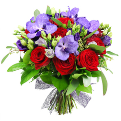 From a bold yet graceful perspective, this bouquet tells a story of love and refined celebration. The plush crimson roses rise among regal purple Vanda orchids, whose broad petals bear a speckled pattern that catches the light with quiet luxury. Interlaced are lisianthus in soft purples, some buds tightly closed, others just opening, adding lavender and almost silver tones to the arrangement. The greenery is lush and varied: broad, glossy leaves and slender stems evoking eucalyptus, plus a swelling of green buds that hints at fresh growth. The stems are secured at the base with a dark, netted ribbon, giving the piece a modern, sculptural edge. Designed to delight on anniversaries, birthdays, or as a dramatic thank-you, this bouquet would brighten a table near Exmouth Market or Smithfield, and it can be delivered on the same day to Clerkenwell and surrounding areas. The bouquet reflects a craftsman's eye for balance, texture, and scent, with the red and purple palette radiating warmth and sophistication. It carries with it the confidence of a professional florist who understands how a bouquet travels-from doorway to dining room-carrying emotion and a touch of luxury.
