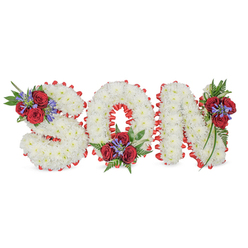 Arranged with the attentive hand of an experienced local florist, this three-dimensional sympathy tribute spells SON in large, sculpted capitals composed entirely of small white spray chrysanthemums. The tiny blooms are tightly clustered to create a soft, even surface that looks almost like freshly fallen snow; under soft studio light the petals pick up cool highlights while retaining a subdued, consoling matte. Each letter is edged with a vivid red satin trim, pleated into a scalloped border that crisply separates the white centre from the surrounding space and emphasises the precise shapes of S, O and N. Three floral clusters add colour and measured contrast: a grouping on the upper-left curve of the S, another nestled in the lower curve of the O, and a final spray resting on the upper-right of the N. Those clusters combine deep red roses with upright blue-purple spikes - reminiscent of liatris or delphinium - and lush dark-green foliage, including delicate fern fronds and trailing leaves that soften the composition's geometry. Tactile details stand out: the roses' velvety petals against the chrysanthemum's feathery texture, the ribbon's satiny sheen and the cool smoothness of the white background. Intended as a personalised memorial for a son, this piece carries traditional symbolism - white for peace and purity, red for enduring love - and would be equally fitting for a service held in a local parish hall, a chapel near St John's Square or a graveside at a nearby cemetery. Clerkenwell Flowers crafts similar tributes for families across Clerkenwell and Farringdon with quiet respect and attention to scent, scale and placement.