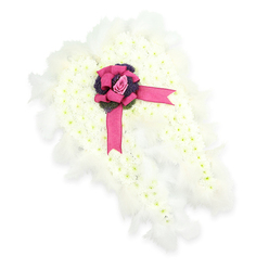 This image shows an angel-wing funeral tribute, carefully shaped by a florist so that both wings curve gracefully towards each other, as if ready to fold someone into a final, protective embrace. The wings are entirely filled with small white chrysanthemums, closely packed so that no gaps of foliage show through, giving a smooth, snowy texture that suggests purity and peace. Soft white feathers trace the outline of each wing, their fine strands slightly ruffled, catching gentle shadows and light to create the impression of movement, like a whisper of air in a quiet chapel near Clerkenwell Green. At the centre where the wings touch, a wide, glossy fuchsia-pink ribbon is tied into an ornate bow, its sheen adding a note of richness and personal sentiment. Cradled within the bow is a single pink rosebud, fresh and delicately spiralled, standing as a symbol of enduring affection and unspoken words. Just below the rose, a tight cluster of deep purple thistles or thistle-like blooms introduces a darker, more textured element, grounding the piece emotionally and visually. The tribute feels both contemporary and timeless, suitable for a funeral or memorial service held in one of Clerkenwell's historic churches or crematorium chapels, and it evokes the sort of thoughtful, custom-made design a local florist might prepare for same-day sympathy delivery to grieving families. The clean white background in the photograph allows every detail-the contrast of white petals, feather edges, satin ribbon and the muted blush of the rose-to be clearly seen and quietly contemplated.