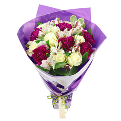 A luxuriously full bouquet stands upright against a white backdrop, its colours and textures reminiscent of a walk through Clerkenwell on a bright spring morning. Creamy white roses form the calm, elegant centre of the design, each bud tightly furled yet soft at the edges, as if moments from unfurling into full bloom. They are surrounded by plush magenta and fuchsia carnations whose densely layered petals create ripples of colour, adding a rich, romantic intensity that contrasts beautifully with the lighter tones. Nestled among them are white alstroemeria, their slender petals gently curving outward, each one traced with fine pink-red streaks and topped with dark, delicate stamens that draw the eye in. The flowers are supported by a generous scattering of glossy green foliage, with a few leaves showing subtle variegated edges that echo the ivory of the roses. This greenery adds depth, freshness, and a sense of natural movement, as though the bouquet has just been gathered from a garden. The stems are carefully arranged to taper neatly, then wrapped in a crisp white paper collar that provides a smart, clean outline. Over this, a layer of translucent purple cellophane or tissue is wrapped in soft folds, its crinkled surface catching the light and giving the bouquet a celebratory shimmer. At the base, a bright, iridescent green satin ribbon is tied into a precise bow, from which a small rectangular kraft-style gift tag dangles, hinting at a personal message from sender to recipient. The arrangement feels joyful and modern, perfectly suited for same-day delivery from a Clerkenwell florist to homes and creative studios around Farringdon Road, Hatton Garden, or St John Street, whether for a birthday, anniversary, or simple gesture of appreciation.