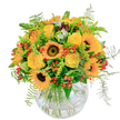 Unmistakably infused with the spirit of a sunlit Clerkenwell afternoon, this lively bouquet radiates the golden splendour of summer spilling into early autumn. At its heart, bold sunflowers with inky centres beam outward, their luminous petals pouring warmth over the entire arrangement. Alongside, bright yellow roses spiral open in buttery, creamy layers-each promising a moment of happiness and celebration for any recipient. Pops of vivid orange and clusters of shiny red berries are woven through vibrant greenery, creating playful contrasts and echoing the colourful harmony found in local flower stalls around Leather Lane. Wispy ferns extend gracefully, lending movement and a sense of gentle meadow breezes drifting in from King Square Gardens. The bouquet is thoughtfully gathered in a rounded, clear glass vase, the stems intertwining in a casual, artful display beneath the water's surface. Its fresh, lightly sweet fragrance-accented by green foliage-suggests early morning market deliveries and the authentic skill of Clerkenwell florists. Designed to uplift, this bouquet is ideal for birthdays, thank-yous, or simply delivering a ray of sunshine to homes and studios throughout EC1, sharing the natural joy and artistry of Clerkenwell with every bloom and leaf.