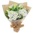 A beautifully composed hand-tied bouquet set upright against a clean white background, celebrating quiet white tones and verdant green contrast familiar to Clerkenwell mornings. At its heart sits a generous cluster of daisy-like white chrysanthemums, each open bloom fanning delicate white petals away from a sunny yellow centre that catches the soft studio light. Rising through the spray are several elongated, pale green-yellow lily buds, some with faint striping, their tapered forms promising a later, elegant unfurling and adding an element of poised anticipation. Scattered like soft clouds throughout the composition are tiny white sprigs of baby's breath (Gypsophila), their airy texture filling negative space and lending an ethereal softness against the denser chrysanthemum heads.
Deep, glossy green foliage anchors the bouquet, the leaves' rich tones giving a crisp, living frame to the pristine whites and enhancing the composition's sense of freshness. The arrangement is carefully gathered and wrapped with an inner layer of crinkled brown kraft paper for an organic, market-style feel, then encased in a clear, glossy cellophane outer layer that protects the stems while allowing the flowers' shapes and subtle colours to show through. The base is neatly gathered and tied, forming a secure, portable stand that suggests a florist's practiced hand.
There is a faint, clean scent-a soft green note like grass after rain and a whisper of sweet pollen-that completes the sensory picture. This bouquet reads as versatile and sincere: fitting for a peaceful sympathy gesture, a gentle get-well wish, or a calm, celebratory gift delivered from a local Clerkenwell florist after a visit to Exmouth Market or a walk past Spa Fields.