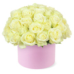 A stylish pastel pink hat box overflows with creamy white and pale ivory roses, meticulously arranged into a full, rounded dome that evokes the gentle elegance often associated with Clerkenwell's galleries and studios. Each rose is lush and velvety, with petals unfurling in soft spirals that reveal the faintest blush of pastel yellow at their centres, hinting at the freshness of early bloom. The roses are clustered tightly together, creating a seamless, cushion-like surface where one blossom blends effortlessly into the next, suggesting abundance without feeling overwhelming. Just at the base, small touches of fresh green foliage peek out between the blooms, offering a subtle contrast that frames the delicate palette rather than competing with it. The hat box, cylindrical and smooth to the touch, has a matte blush-pink finish that feels modern and luxurious, similar to high-end gift packaging you might find in a boutique off Clerkenwell Road. Illuminated by soft, even light, every petal edge, fold, and curve is gently defined against the pure white background, keeping the viewer's focus entirely on the craftsmanship and composition of the arrangement. The overall impression is one of quiet romance and thoughtful celebration, ideal for a special anniversary, a heartfelt thank-you, or a romantic delivery to an apartment near Farringdon. It reflects the skill of a dedicated local florist who understands how to blend classic roses with contemporary presentation, creating a piece that feels both timeless and perfectly at home in modern Clerkenwell life.