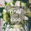 Clerkenwell Flowers presents a radiant Florist Choice Bouquet in white and lime green, a testament to refined craftsmanship. The bouquet centers on two large white lilies with petals unfurled, surrounded by layers of white ranunculus or spray roses that create a cloudlike fullness. Lime-green clusters-textured and vivid-provide a contemporary pop, reminiscent of Green Trick dianthus or compact hydrangea. Dark, glossy foliage such as eucalyptus and ruscus threads through the stems, giving depth and a lush, forest-like frame. The arrangement appears hand-tied and is held by a figure in pale attire against a softly blurred wedding setting, suggesting a ceremony or celebration in Clerkenwell near Exmouth Market or the Barbican. In the center is a white frame bearing Florist Choice script at the top, CHOICE BOUQUET in uppercase with short dashes on either side, and the bottom displays the bold ?200 price, signaling a premium gift. Available for same-day delivery across Clerkenwell, Holborn, Farringdon, and surrounding districts, this bouquet embodies celebration, purity, and modern luxury-an ideal gift for weddings, anniversaries, or milestone moments delivered by Clerkenwell Flowers. It exudes a fresh fragrance that blends the lily scent with green notes, and the stems are neatly bound with a natural tie, finishing with a clean line that speaks of careful preparation in our Clerkenwell workshop. Delivery is reliable and refreshingly prompt.