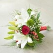 Laid diagonally on a clean, pale surface, this lush hand-tied bouquet is a celebration of both nature and the artsy spirit of Clerkenwell. At the upper left, stately white lilies bloom with sculptural precision, some wide open to reveal golden-centred stamens edged in subtle speckles, others tightly budded and luminous green-a suggestion of hope and renewal. Dominating the heart is a single sumptuous red rose, whose velvety spiral of petals draws the eye with an air of timeless romance, echoed by the glossy crimson of scattered hypericum berries. Cushions of moss-green button-like dianthus sweep through the bouquet, offering plush texture, while delicate wisps of gypsophila drift softly between showier blooms. The entire composition is anchored by a generous surround of mixed foliage, from broad, shining leaves seen in local gardens to fine, feathery fronds, creating depth and fullness. Tied with a bright red satin ribbon that catches the light-an elegant nod to Clerkenwell's fashion ateliers-the bouquet brims with energy and refined celebration. This vibrant arrangement, created by local florists for delivery across Clerkenwell and Islington, would be equally at home gracing a wedding, brightening a milestone anniversary, or expressing heartfelt joy on a special day, embodying both the classic and contemporary style beloved in the EC1 area.