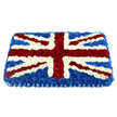 A carefully crafted Union Jack floral tribute dominates the scene, its strong lines and rich colours echoing the sense of history felt around Clerkenwell's churches and memorials. The arrangement is rectangular and slightly domed, made from hundreds of closely clustered blooms that blend into a seamless flag design. Deep blue chrysanthemums create the background field, their dense petals giving a velvety, almost textile effect. Over this, the white of St George's Cross appears as broad, bright stripes running centrally from top to bottom and side to side, each petal turned outward like tiny stars. Diagonal bands of vivid red carnations cross at angles, representing St Patrick's Cross, with slim borders of white blooms keeping every section of the pattern crisp and true to the Union Jack. The flowers are packed so tightly that the surface appears smooth yet softly padded, suggesting a tender, consoling touch when seen atop a coffin or displayed at a remembrance service. Along the bottom edge, a pleated royal blue satin ribbon finishes the tribute with formal elegance, similar to the refined trimmings seen at ceremonial events near Clerkenwell Green. The lighting is gentle and even, highlighting the freshness of the petals and the depth of colour without casting harsh shadows. Overall, this floral flag speaks of honour, respect, and affection, making it a powerful statement for military funerals, national commemorations, or farewells for someone who took pride in their British identity and London life.