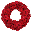 Set against a pale, luminous background, this lush wreath is built entirely from dozens of fresh, deep red roses, their heads full and velvety, with no green sprigs breaking the circle. The ring is a seamless, hollow-centered circle, inviting the eye to move around its circumference. Each rose sits tightly to its neighbour, creating a continuous, opulent texture that whispers of luxury and care. Large, fully opened blooms dominate, their petals curling in gentle, sculptural spirals, while smaller, mature heads fill the gaps with quiet rhythm. The overall colour glows with a rich ruby shade, a timeless symbol of love, remembrance, and respect, making it an ideal centerpiece for memorials, anniversaries, or refined romantic gestures. In our Clerkenwell workshop, we craft pieces like this with the same meticulous attention we give to orders from neighbours around St John's Gate and Leather Lane; it is designed to travel promptly to households across Clerkenwell, Farringdon, and nearby areas, preserving freshness and fragrance as it arrives. A timeless choice that communicates devotion with understated elegance, and a wreath that crowds the senses with the scent of roses and the memory of moments shared.