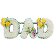 A tender, three-dimensional memorial spelling the word DAD in bold, freestanding capital letters, each letter formed from a dense, pillowy bed of pristine white blossoms - the small, clustered spray chrysanthemums (or spray carnations) give every letter a soft, cloud-like texture. The outer and inner contours are crisply finished with a ruffled dark-green satin ribbon that reads as a neat frame against the white mass, while slim, dark-green metal support bars run horizontally behind the letters, visible and reassuring, holding them together as one cohesive tribute. On the left-hand 'D' a radiant cluster of three to four sunlit yellow roses is positioned on the upper curve, offset with tiny white freesias and fresh green foliage; two long, bare green stems arch diagonally from that cluster, reaching gently toward the centre A as if tracing a memory. The central 'A' carries a quieter, elegant accent low on its left diagonal: two deep purple, almost burgundy calla lilies rise like small trumpets, their smooth, sculptural forms surrounded by delicate white filler and glossy leaves, bringing a note of reverence. The right-hand 'D' mirrors the left with the same cheerful yellow rose grouping on its upper right curve, balancing the composition. The arrangement reads cleanly against a plain white background, the colours-pure white, rich dark green, bright yellow and velvety purple-working together to convey calm, dignity and affectionate remembrance. The scent is faint and comforting: a subtle, fresh floral sweetness with the soft green note of leaves. Designed for funeral or memorial display, this piece shows careful craftsmanship and a quiet elegance that comforts those saying goodbye in Clerkenwell and nearby neighbourhoods such as Exmouth Market and Spa Fields.