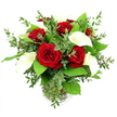 A full, rounded bouquet of crimson red roses and creamy white calla lilies rests in a simple clear glass vase, set against a pure white background that lets every detail stand out with gallery-like clarity. At the heart of the composition, six or seven roses bloom in deep, velvety crimson, their petals unfurling in intricate spirals that suggest whispered declarations and long walks around Clerkenwell's cobbled lanes. Piercing the mass of red, several calla lilies rise with quiet strength, each one a sleek, trumpet-shaped bloom of cool ivory, its surface smooth and almost waxen, folding gently around a slender yellow spadix. The contrast between the roses' plush texture and the lilies' sculptural simplicity creates a sophisticated tension, as if passion and calm are held together in a single breath. Around these focal flowers, a generous mix of greenery adds movement and structure: eucalyptus stems with their slender, silvery-green leaves weave in and out, imparting a light, contemporary feel, while larger, darker green leaves create a strong, verdant collar that frames the central flowers much like the green pockets around Spa Fields. The stems are bound neatly and visible through the vase, standing in clear water above a subtle ribbed detail at the base. Bright, clean lighting floods the scene, making reds richer, whites crisper, and greens more vibrant, without any distraction from the uncomplicated background. The finished effect is of a modern romantic statement, perfect for an anniversary surprise delivered to a studio near Farringdon, a Valentine's gift, or a striking centrepiece for an intimate gathering in the heart of Clerkenwell.