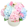 In a pristine white round hatbox, this bouquet unfolds like a quiet poem in soft pastels. The dominant blush comes from lush pink peonies, their many petals catching light and giving the arrangement a sense of plush abundance. Cloud-like clusters of baby blue hydrangeas provide a cool counterpoint, while delicate pale pink spray roses and tightly furled rosebuds add texture and intimate detail. Two deep pink calla lilies stand as sculptural accents, one tucked near the top left of the composition and the other peeking gracefully from the bottom right. Subtle green notes trail through the arrangement-hydrangea leaves with a hint of dusty miller-framing the blooms with a silvered glow. The whole is crafted into a full, rounded dome, a look of refined luxury that feels appropriate for celebrations and heartfelt moments alike. The white hatbox sits against a pure white backdrop, turning the focus to the flowers themselves, as if the blooms were being presented in a private studio just off Clerkenwell Green, within a short walk of Exmouth Market. This bouquet speaks of birthdays, anniversaries, baby showers, or gender reveals, conveying romance and gentle sophistication in equal measure. It is the kind of arrangement a local artisan would create with the patient hands of someone who knows the neighbourhood intimately, imagining the smiles of recipients in nearby streets and parks. Available for same day delivery across Clerkenwell and the surrounding boroughs, it carries the signature warmth and craftsmanship of Clerkenwell Flowers, your trusted neighbourhood florist.