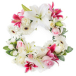 A large, circular sympathy wreath fills the frame, presented against a clear white background so every petal and leaf stands out with gentle clarity. The ring is dominated by stately white oriental lilies, their wide-open petals forming soft stars, with pale green pistils and golden-tipped stamens offering subtle detail at the heart of each bloom. Nestled between them are vibrant deep pink and fuchsia lilies, some delicately speckled, adding a ribbon of rich colour that runs around the wreath without overpowering its calm, respectful mood. Crisp white gerbera daisies, each with a dark central eye and concentric layers of petals, break up the larger shapes and lend a contemporary touch suited to a memorial service in Clerkenwell's modern venues and historic churches alike. Soft blush pink roses and creamy white roses, some still in bud and others fully unfurled, are tucked throughout the design, their velvety, spiralled petals symbolising love, remembrance, and gratitude. Smaller white accent flowers-likely sprays of carnations or miniature roses-fill in any spaces, making the circle look plush, complete, and unwavering. A foundation of deep, glossy green foliage holds the arrangement together, adding depth, dimension, and a natural frame to the ring. The overall impression is one of quiet elegance, as if carefully prepared in a local Clerkenwell workshop for same-day delivery to a funeral, wake, or celebration of life. This wreath visually conveys eternal love and respect, an unbroken circle offering comfort and solace to family and friends gathered to say goodbye.