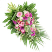A thoughtfully arranged funeral spray lies diagonally across a white backdrop, its design flowing from the crowded fullness of the upper left down to a more tapered, trailing lower right, much like a gentle bow in farewell. The palette is dominated by pinks and fuchsias, balanced with fresh whites and layered greens to create a tribute that feels both heartfelt and composed. Open-faced gerbera daisies in pale pink and deep magenta serve as the main stars, their radiating petals adding a sense of brightness and openness. Interwoven among them are refined pink roses, each bloom with a tightly coiled centre gradually opening outward, echoing the tender emotions of remembrance that often accompany services in Clerkenwell's chapels and community spaces.
Between these focal flowers sit clusters of fluffy white blooms, likely carnations or small chrysanthemums, lending softness and volume, while tiny white daisy-like flowers dance lightly throughout, giving the arrangement an airy, almost whispering quality. Bright red hypericum berries dot the greenery, introducing small, jewel-like accents that catch the eye. Beneath and around the flowers, a tapestry of foliage in varying shades of green provides structure and rhythm: broad, deep green leaves anchor the composition; feathery ferns soften the silhouette; and cool, silvery eucalyptus leaves add a subtle modern touch and hint of fragrance. Toward the lower right, long, slender palm fronds extend outward, amplifying the cascading effect characteristic of traditional funeral sprays. At the upper left, a neat bundle of exposed stems reveals where the florist has securely tied the piece. Crafted with the sensitivity of a local Clerkenwell florist, this arrangement feels appropriate for casket adornment or as a prominent tribute at a memorial, offering visual comfort and a message of enduring love.