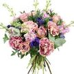 A lush, hand-tied bouquet is photographed against a stark white background, making its rounded, abundant shape and subtle colour shifts immediately draw the eye. At the centre sit graceful roses in soft dusty pinks and muted peach tones, some fully open to reveal layered, swirling petals, others still held in gently pointed buds that suggest blooms yet to unfold. Embracing them are lavish carnations with their distinctive ruffled edges, each blossom showing a delicate blend of magenta, mauve, and blush that fades inward to creamy centres, giving the arrangement a richly textured, almost cloud-like quality. Scattered among these pastels, deep indigo and violet-blue anemones provide striking accents, their nearly black centres adding depth and a touch of drama, as if echoing the contrast between Clerkenwell's historic brickwork and its sleek modern interiors. Woven throughout the bouquet, tall stems of lavender and pale pink stock introduce a vertical rhythm; their many tiny flowers cluster together along the stems, adding a soft, feathery look and hinting at a light, soothing fragrance reminiscent of weekend walks through nearby parks and secluded courtyards. Surrounding all of this is a generous collar of greenery: round, silvery eucalyptus leaves catch the light with a cool sheen, while deeper green foliage creates a rich, grounding base that enhances the bouquet's volume. The natural stems are gathered by hand at the bottom, clearly visible and slightly fanned, underscoring the artisanal care typical of experienced Clerkenwell florists. The overall effect is one of elegant calm and tender emotion, well suited to mark birthdays, quiet congratulations, or simply to bring a sense of gentle luxury into a flat or studio overlooking Clerkenwell Road.