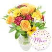 Against a crisp white background a joyful gift set sits serenely: a lush bouquet in a clear glass vase beside a round white foil balloon that reads best Mum in flowing hot-pink script. The arrangement has a warm, golden glow - several full, peachy-orange roses take centre stage, their velvety petals unfurling in soft spirals that catch the light like small suns. Bright yellow gerbera daisies punctuate the display with flat, cheerful faces and deep brown centers that anchor the palette. Deep burgundy carnations with tightly ruffled edges add a plush, velvety counterpoint, their texture folding into and around the roses. Small white alstroemeria, each with slender, slightly speckled petals, thread through the composition to bring delicate contrast and a whisper of perfume. A generous cloud of glossy green foliage - broad leaves and thin sprigs - cradles every bloom, giving the bouquet structure and a freshly-cut garden feel; through the transparent vase you can see neatly trimmed stems standing in clear water, a detail that signals care and freshness. The round foil balloon, positioned to the lower right and slightly overlapping the vase, is playfully dotted with scattered gold and fuchsia confetti spots and tiny heart shapes, adding sparkle and a celebratory note. The overall effect is intimate and upbeat - a carefully balanced offering that reads as both elegant and affectionate, perfect for Mother's Day or a birthday treat. As a local Clerkenwell florist I imagine this bright bouquet arriving on a morning walk past Exmouth Market, bringing colour and scent into a small flat or kitchen table where it will make a mum smile.