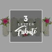 This image showcases a carefully arranged display of floral letters, photographed against a smooth light grey backdrop that allows every detail of the tribute to stand out. In the centre, a semi-transparent dark grey rectangle rests over the flowers, carrying white text that reads 3 LETTER in a neat, modern font, with the word Tribute beneath in a flowing script, identifying this as a classic three-letter funeral design. Behind the overlay, several robust, upright shapes are formed entirely from densely packed white chrysanthemums or similar small white flowers, their rounded petals layered to create a plush, uniform surface. On the left, a clearly defined letter M can be seen, its top left corner decorated with a small spray of vivid pink roses and paler pink buds, accompanied by arching fronds of fresh green fern. To the right of this, three tall rectangular forms stand side by side, also covered in white blooms, suggesting the vertical strokes of additional letters. Further along, another upright floral shape, likely the start of an N or similar letter, is visible, with pink rose clusters accenting its upper right and lower right corners. Throughout the composition, the interplay between snowy white petals, vibrant pink roses, and airy green foliage brings gentle colour and life to what is clearly a memorial piece. The neat, studio-style lighting reveals every texture without glare, reflecting the kind of careful presentation a Clerkenwell florist would offer when creating personalised sympathy tributes for families gathering near Farringdon Station, Spa Fields, or the quiet side streets off Clerkenwell Road.